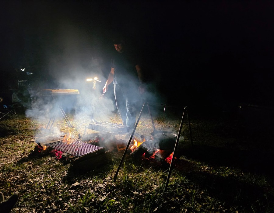Campfire cooking at night